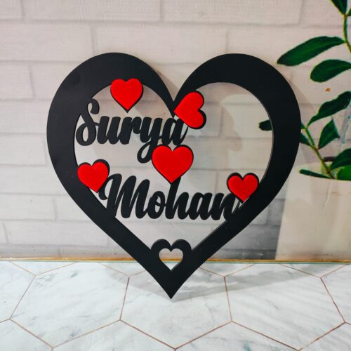 This gift is a heart-shaped centerpiece personalized with the couple's names, perfect for celebrating their love.